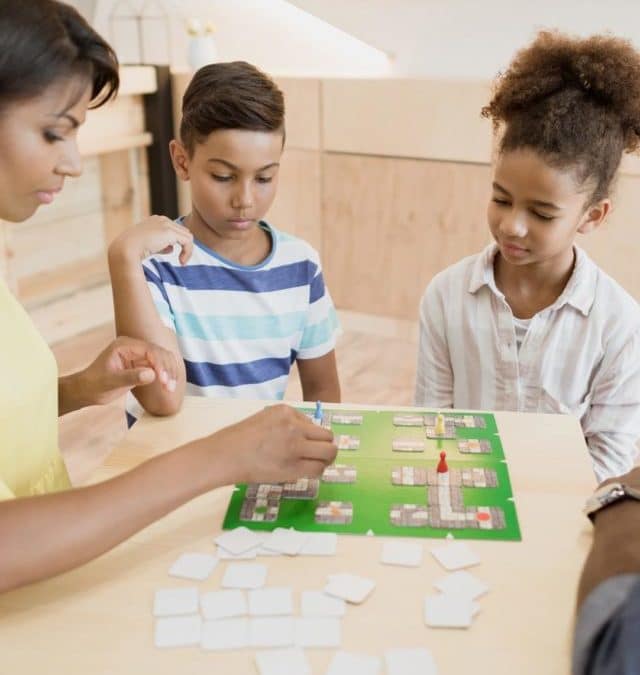 cropped-african-american-family-playing-board-game-in-cafe-2021-08-29-11-20-51-utc.jpg