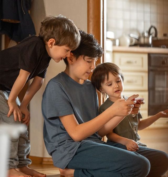 cropped-three-brothers-sit-at-home-on-the-floor-and-play-g-2022-03-02-08-15-46-utc.jpg
